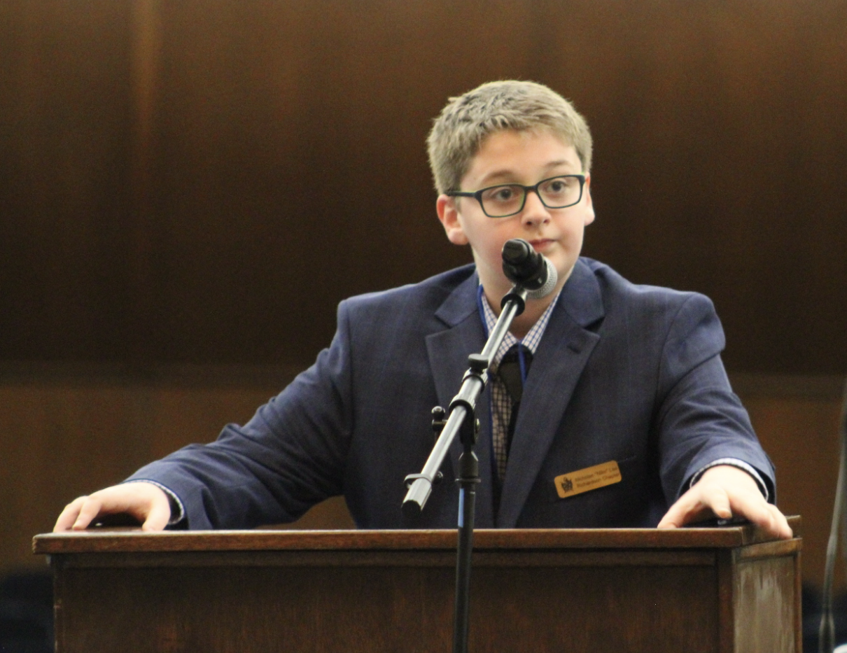 One of our members speaking at a podium.